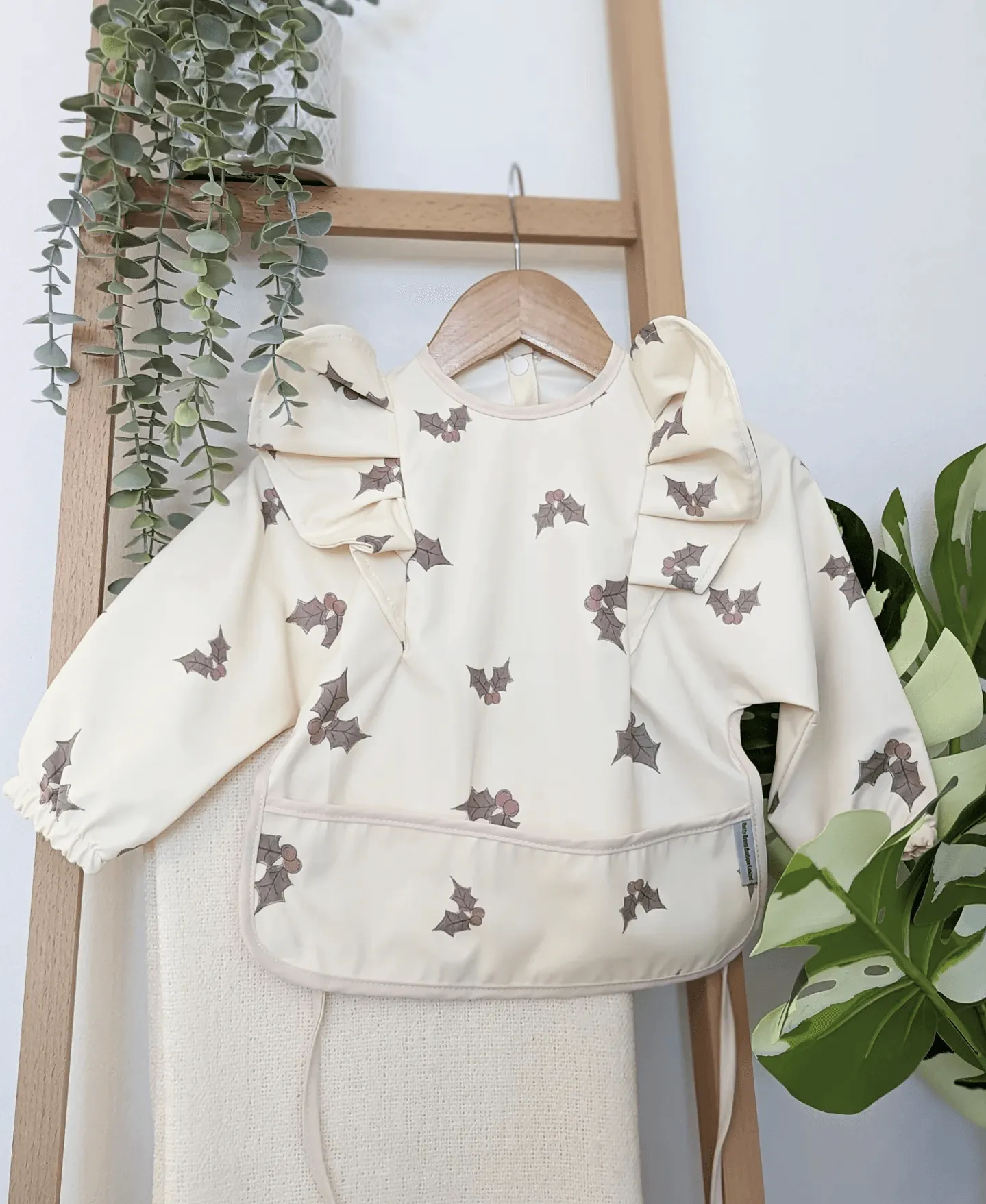 Cream Holly Print Frill Detailed Waterproof Bib with Sleeves - Limited Edition Christmas Collection