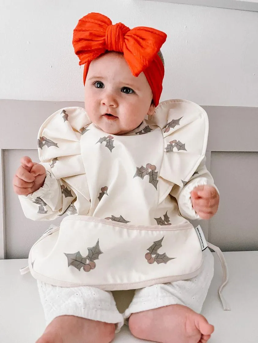 Cream Holly Print Frill Detailed Waterproof Bib with Sleeves - Limited Edition Christmas Collection